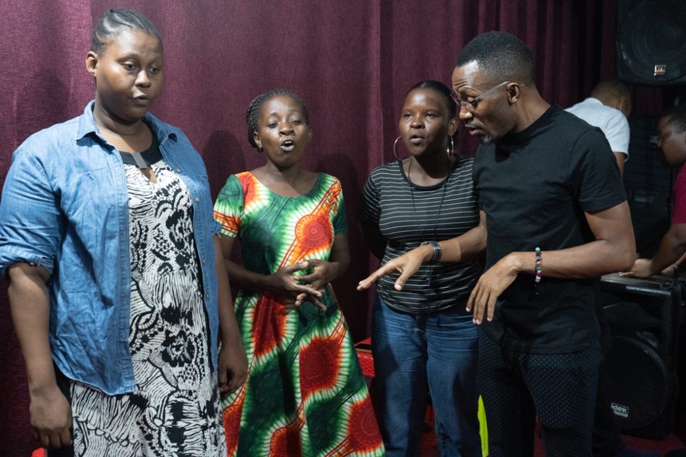 Elidadi directs the choir