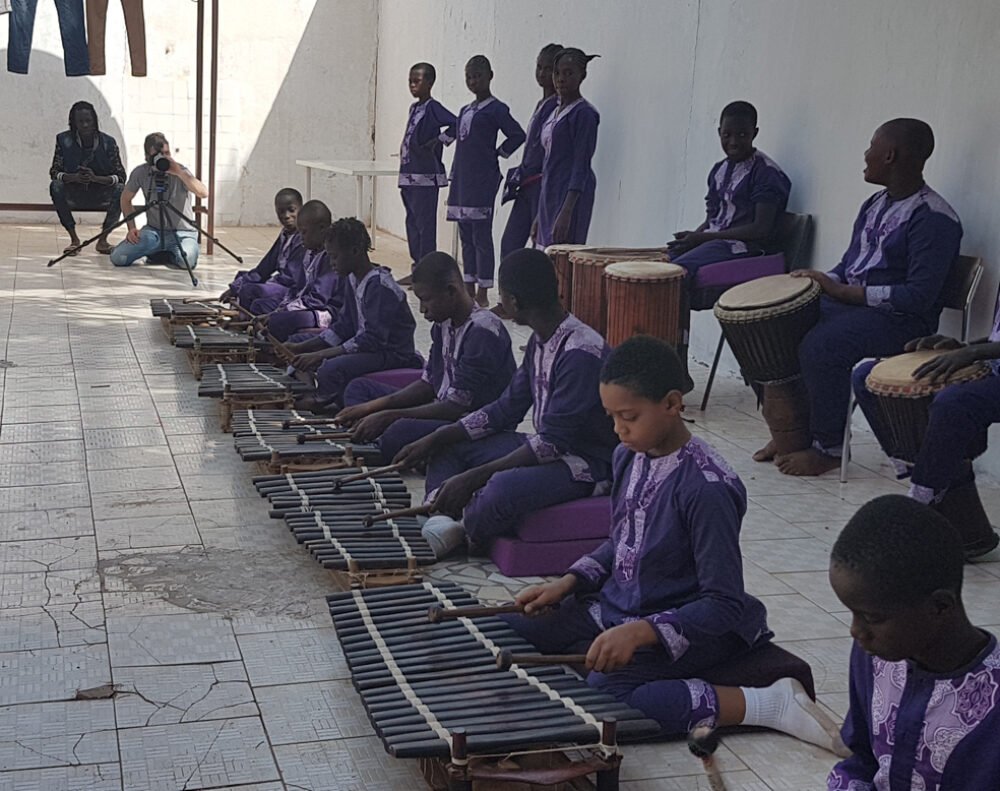 Students performing on kora, balafon and djembe.